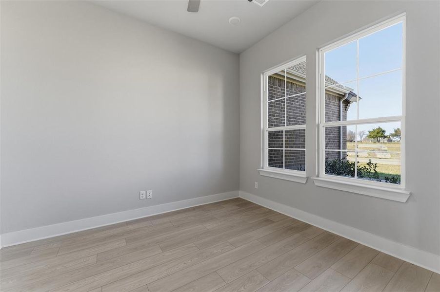 Spare room with light wood-style flooring and a ceiling fan