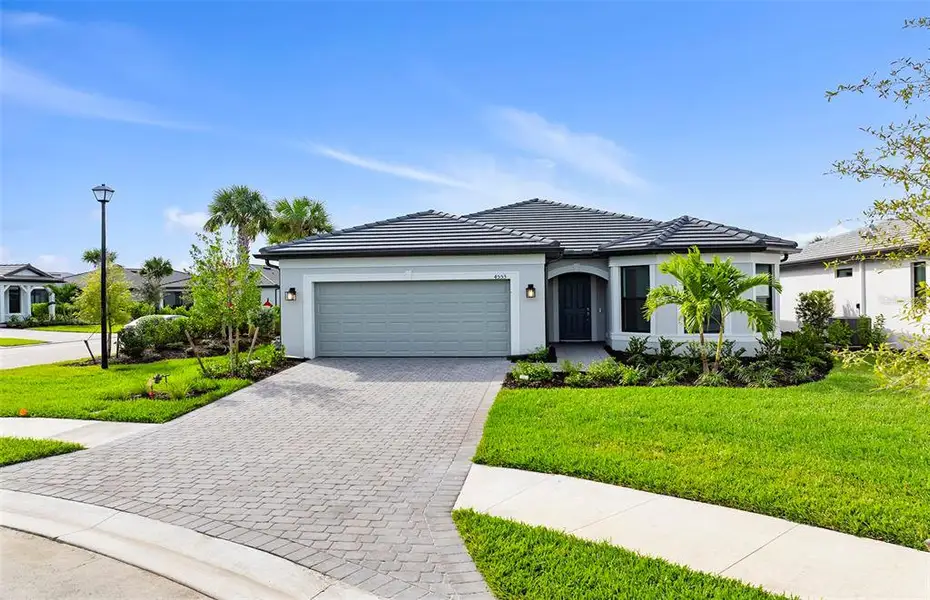 Front exterior of a new home in , North Port, FL, highlighting curb appeal (Image 2). Front exterior of a new home in , North Port, FL, highlighting curb appeal (Image 2).