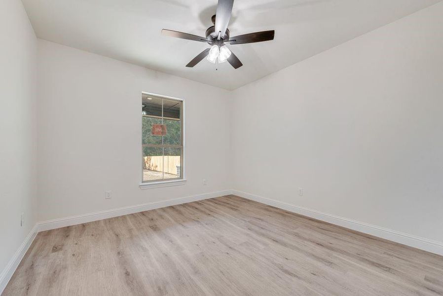 Spare room featuring light hardwood / wood-style floors and ceiling fan