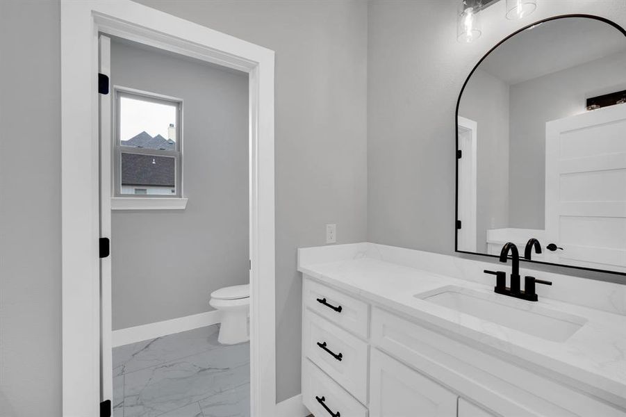 Bathroom with vanity, tile patterned flooring, and toilet