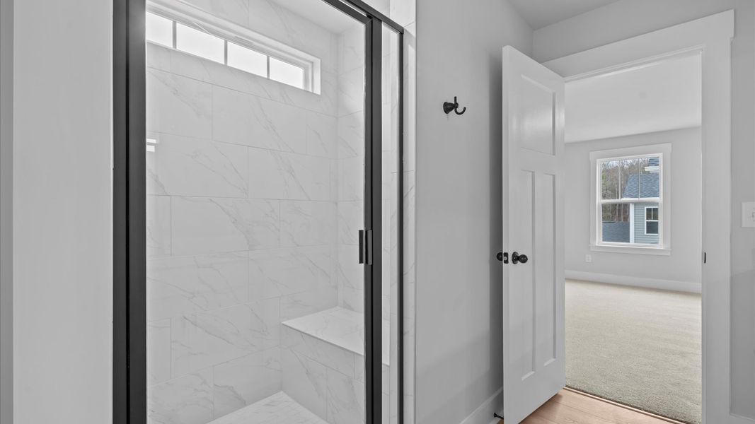 Highly functional and elegant en-suite with dual vanities, tiled walk-in shower, and refined finishes