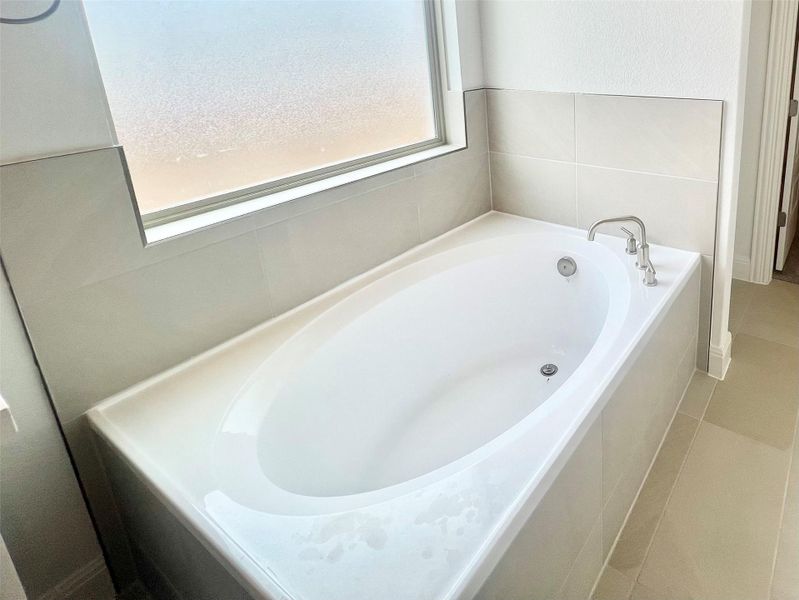 Full bathroom featuring a bath Full bathroom featuring a bath