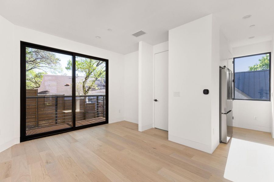 Unfurnished room featuring light wood-type flooring and healthy amount of natural light
