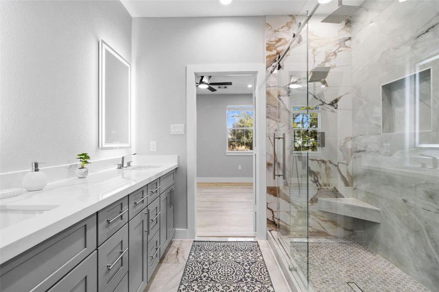 This angle shows how thoughtfully designed your space really is—dual vanities with generous counter space, modern cabinetry, and integrated lighting that’s both functional and flattering. It’s bright, calm, and designed for real everyday use without sacrificing style. This angle shows how thoughtfully designed your space really is—dual vanities with generous counter space, modern cabinetry, and integrated lighting that’s both functional and flattering. It’s bright, calm, and designed for real everyday use without sacrificing style.