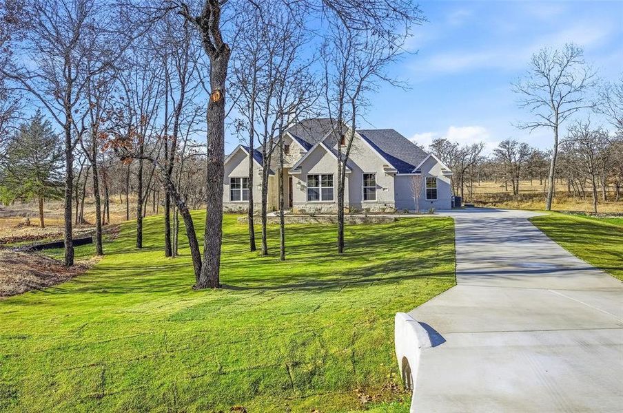 Front exterior of a new home in Escondido Ranches, Poolville, TX, highlighting curb appeal (Image 24).