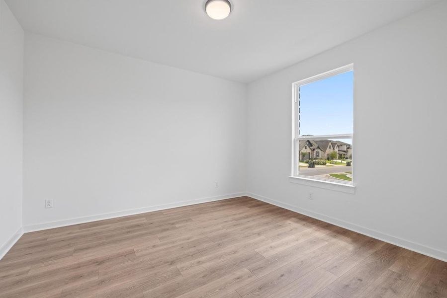 Empty room with light wood-type flooring and baseboards Empty room with light wood-type flooring and baseboards