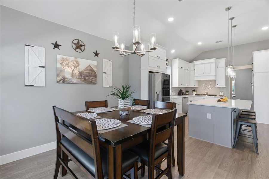 Open concept kitchen and dining area featuring light wood-finish flooring