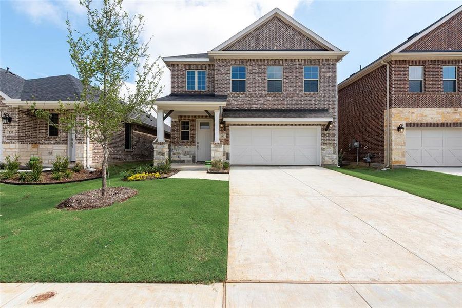 Front exterior of a new home in Spiritas Ranch, Little Elm, TX, highlighting curb appeal (Image 21).