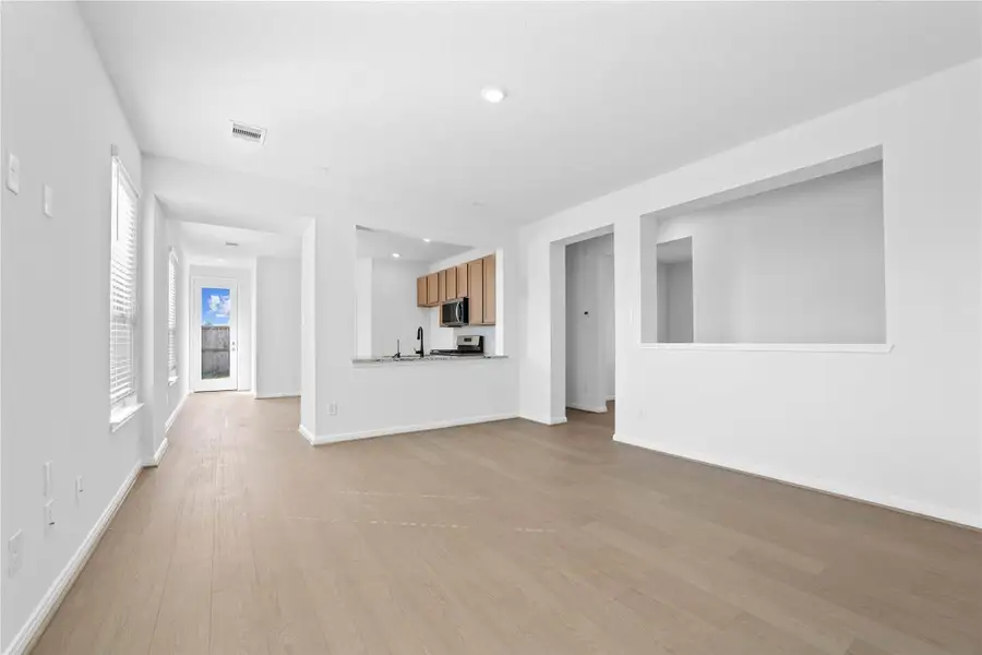 Designed for comfort and connection, this spacious open-concept great room boasts soaring ceilings, large windows with blinds, recessed lighting, and French Oak vinyl plank flooring, seamlessly merging with the stunning kitchen for easy living and entertaining. Designed for comfort and connection, this spacious open-concept great room boasts soaring ceilings, large windows with blinds, recessed lighting, and French Oak vinyl plank flooring, seamlessly merging with the stunning kitchen for easy living and entertaining.