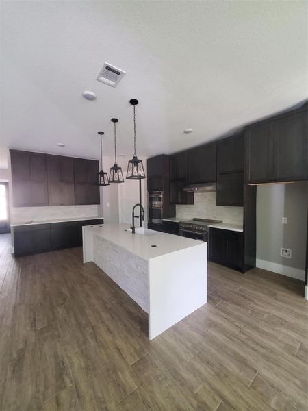 SIDEVIEW OF THE KITCHEN WITH WATERFALL ISLAND AND SOFT-CLOSING EUROPEAN HIDDEN HINGE CABINETS WITH HARDWARE INCLUDED. SIDEVIEW OF THE KITCHEN WITH WATERFALL ISLAND AND SOFT-CLOSING EUROPEAN HIDDEN HINGE CABINETS WITH HARDWARE INCLUDED.