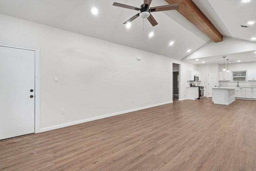 Living room area with modern flooring, open concept