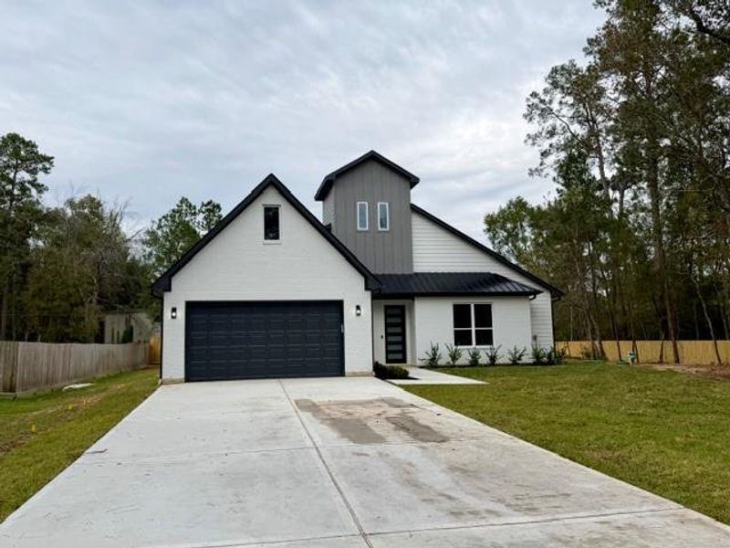 Front exterior of a new home in , Magnolia, TX, highlighting curb appeal (Image 2). Front exterior of a new home in , Magnolia, TX, highlighting curb appeal (Image 2).