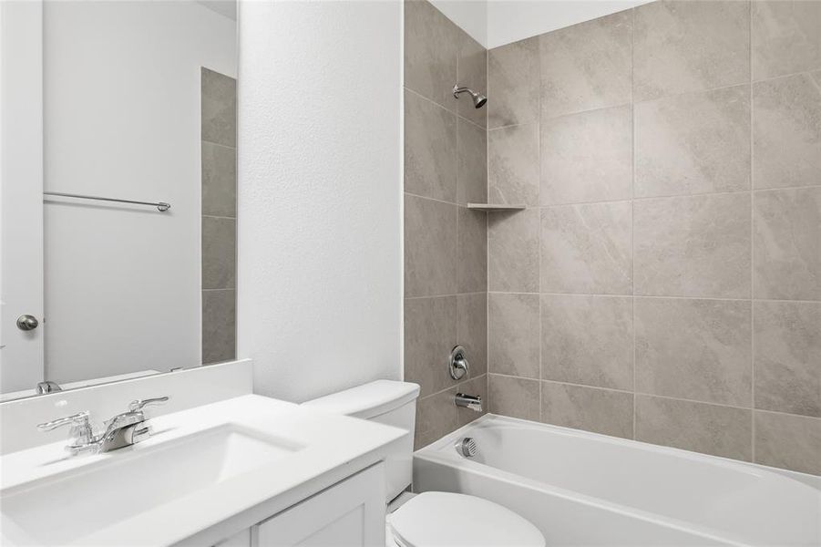Bathroom featuring a white vanity with integrated sink, chrome faucet, and full-width mirror
