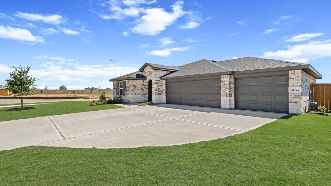 Front exterior of a new home in Sunterra Lakes, Brookshire, TX, highlighting curb appeal (Image 2). Front exterior of a new home in Sunterra Lakes, Brookshire, TX, highlighting curb appeal (Image 2).