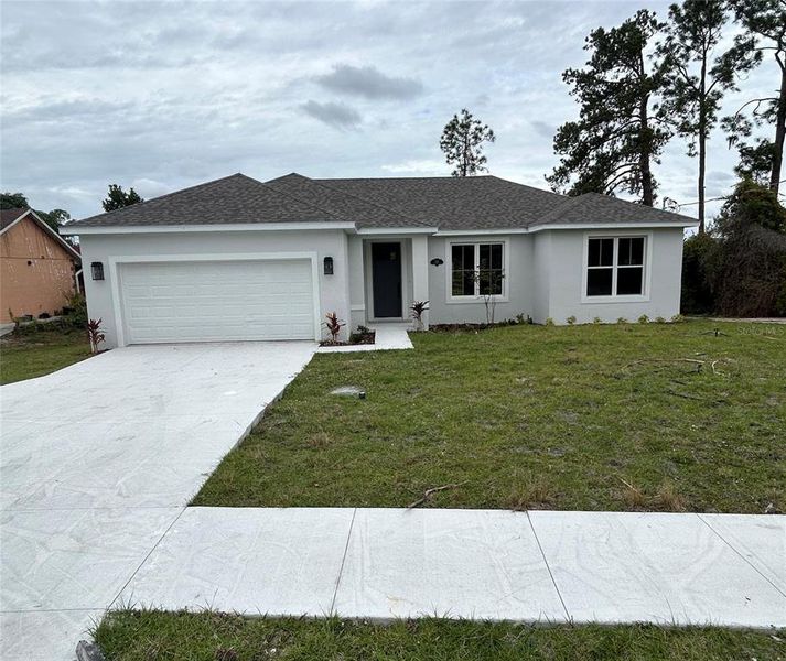 Front exterior of a new home in , Deltona, FL, highlighting curb appeal (Image 2).
