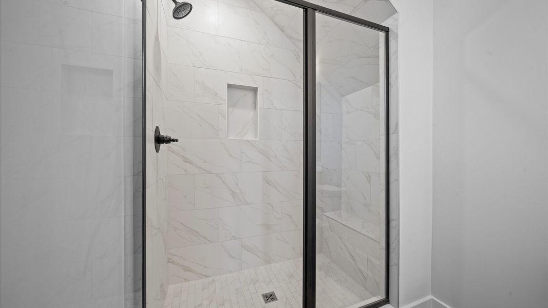 First-rate primary bathroom offering an elegant tiled walk-in shower and dual sinks with superior style