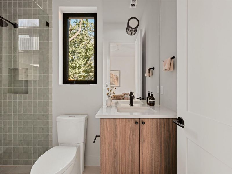 Full bathroom with vanity, a tile shower, and tile patterned flooring