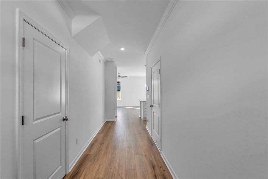 This spacious hall features light hardwood floorin