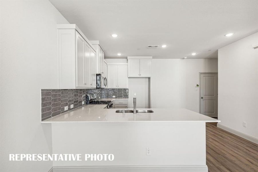 The kitchen peninsula, featuring a breakfast bar, is the perfect place for a quick meal or homework station.  REPRESENTATIVE PHOTO