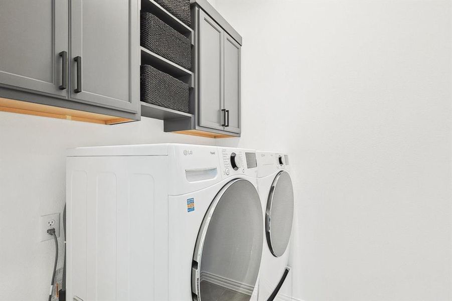 Washroom with independent washer and dryer and cabinets