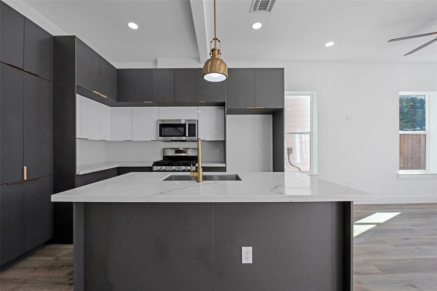 The tall cabinets to the left provide storage for pantry items. The drawers and cabinets are soft close.