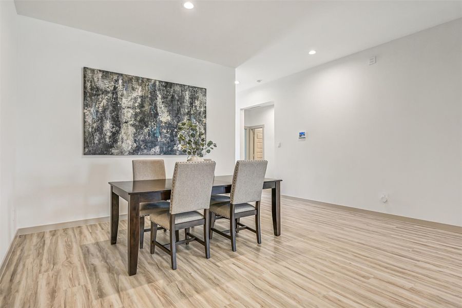 Spacious and open to the adjoining kitchen, the dining area offers plenty of room for a large table while maintaining an easy connection to the home's main gathering spaces. Spacious and open to the adjoining kitchen, the dining area offers plenty of room for a large table while maintaining an easy connection to the home's main gathering spaces.