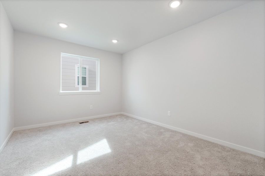 A room with a window and a carpet. A room with a window and a carpet.