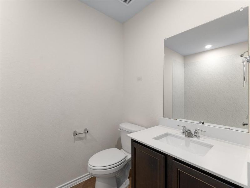 Bathroom featuring vanity and toilet