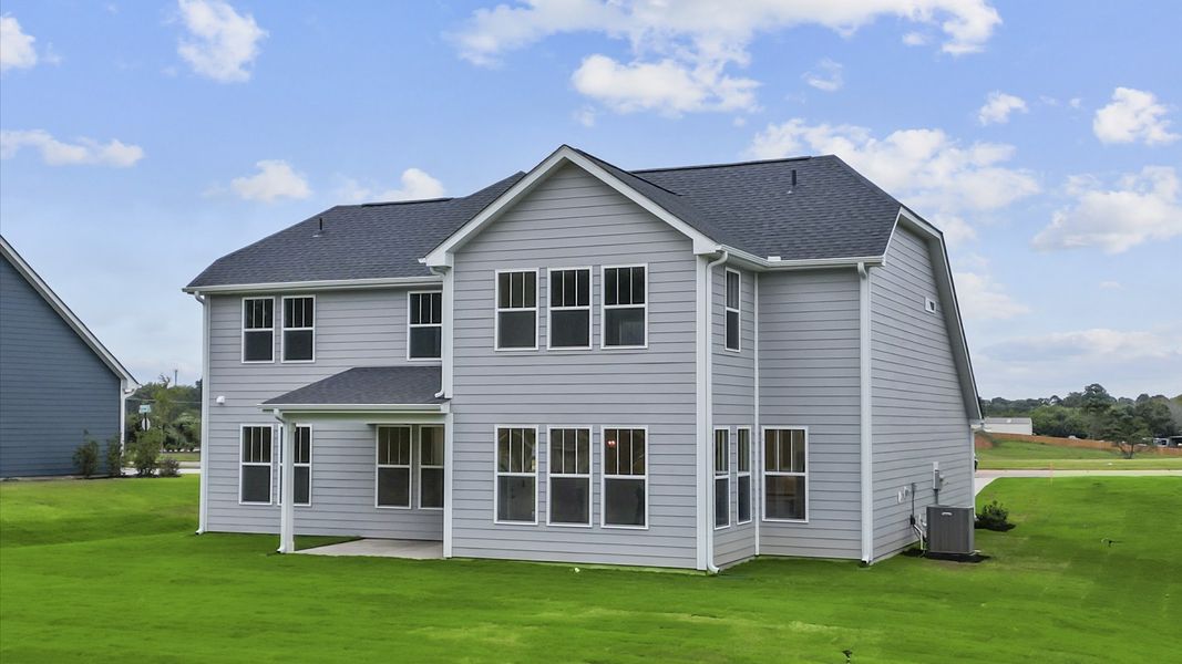 Exceptional outdoor living begins with a covered back porch in this thoughtfully designed home