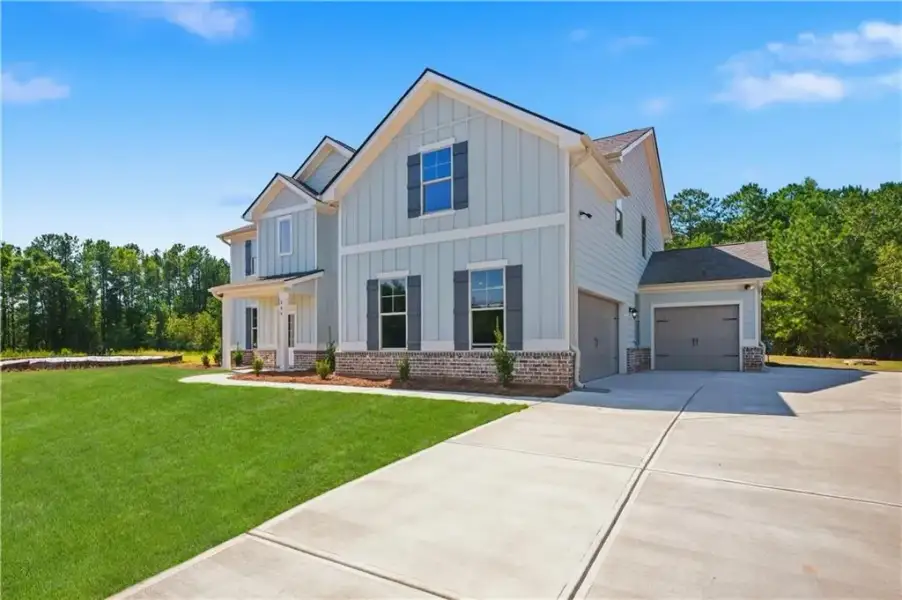 Front exterior of a new home in Brighton, Locust Grove, GA, highlighting curb appeal (Image 20).