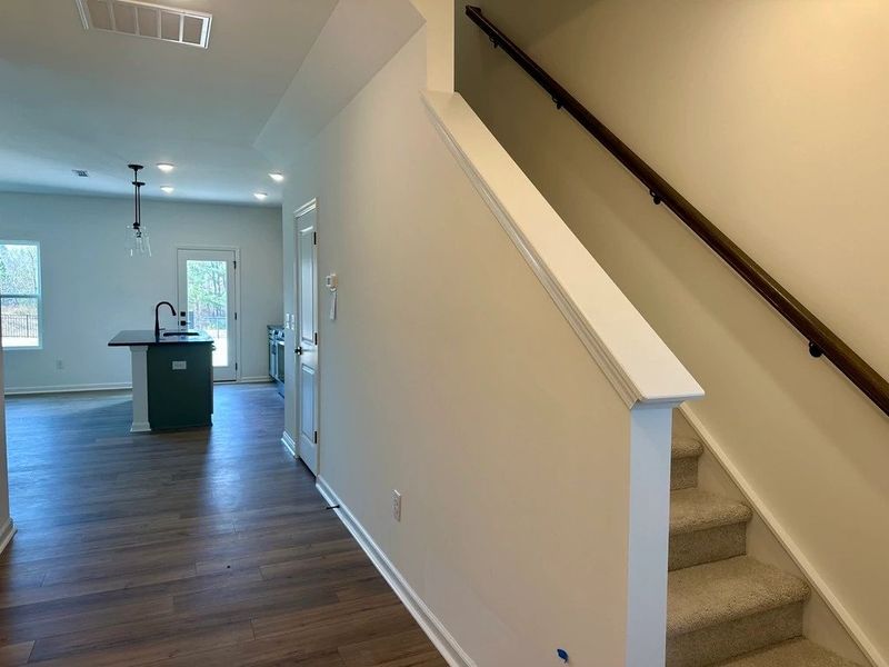 Foyer featuring the AW Collection® Rosemary - Natural light and bold color create grounded warmth.