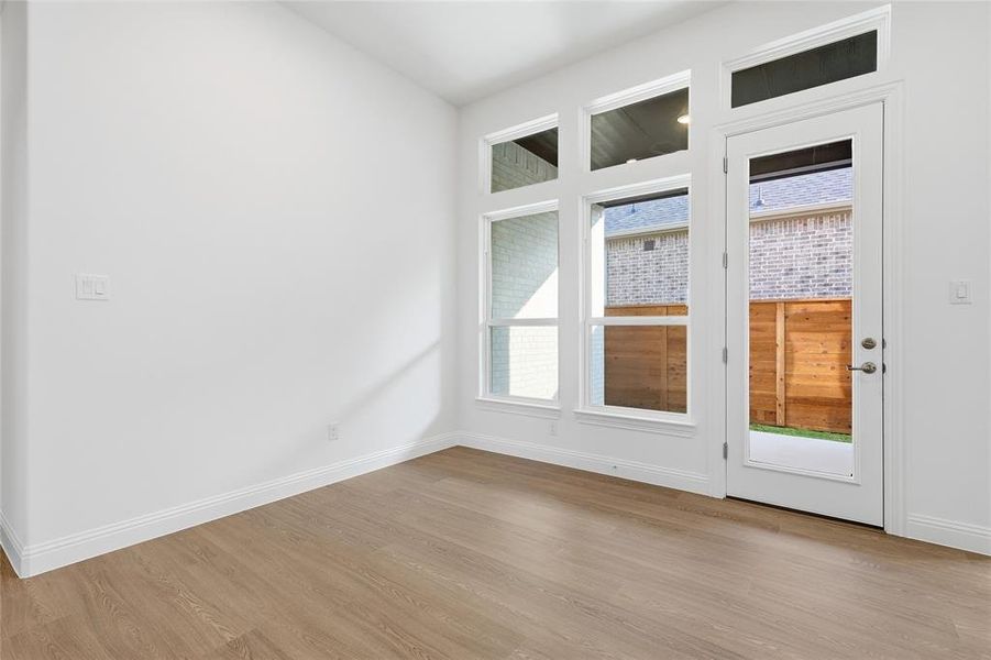 Spare room with light wood-style flooring and baseboards