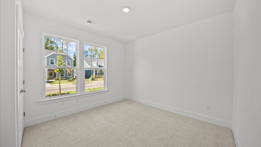 Memorable space with walk-in closet, soft carpeting, and striking natural light from large windows