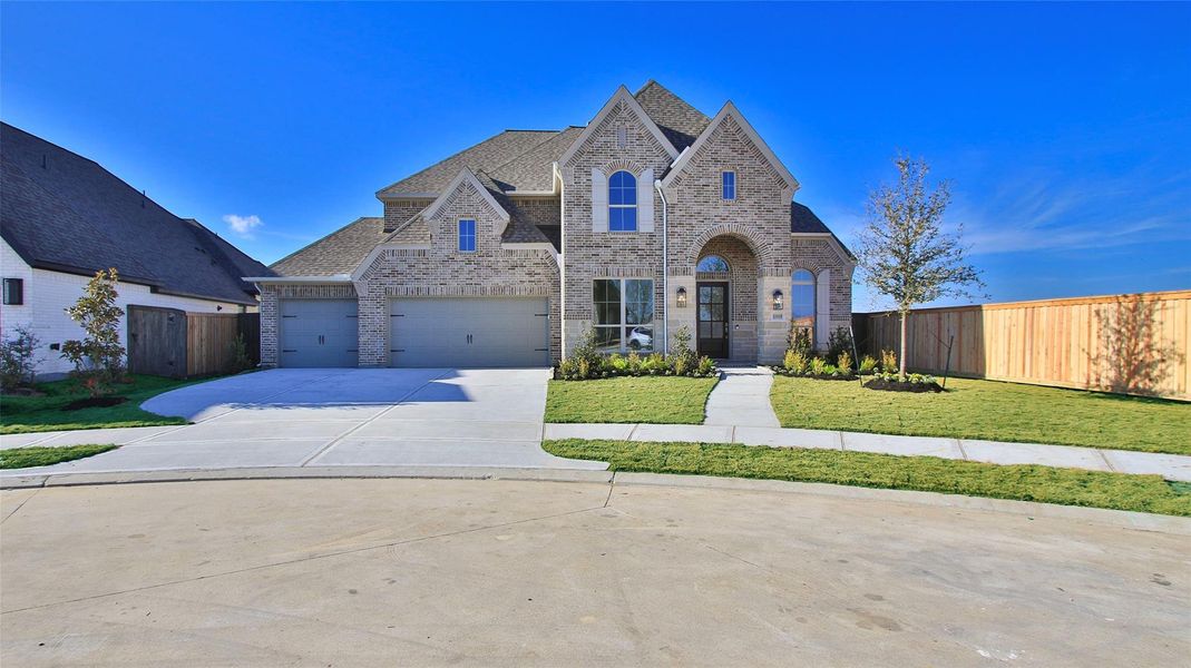 Front exterior of a new home in Riceland, Mont Belvieu, TX, highlighting curb appeal (Image 2).