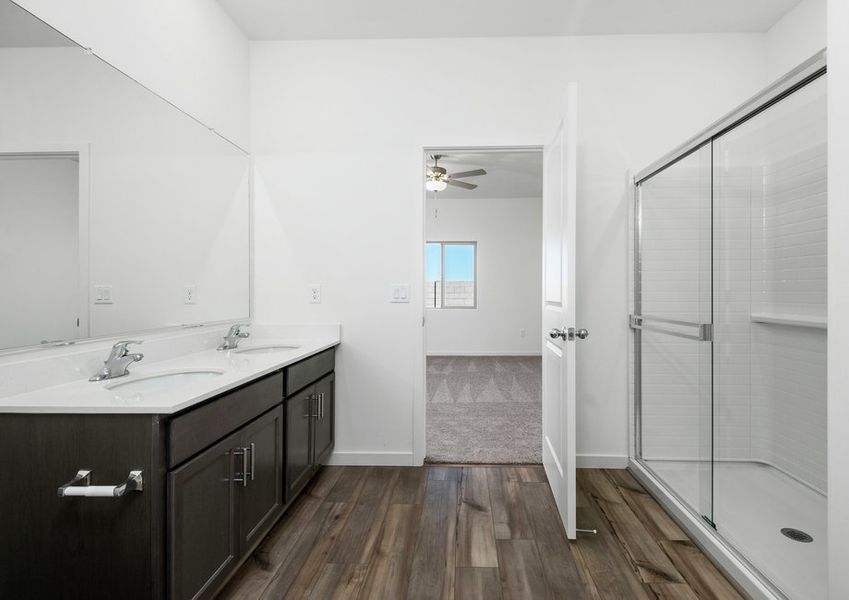 The master bath has a spacious, glass-enclosed shower.