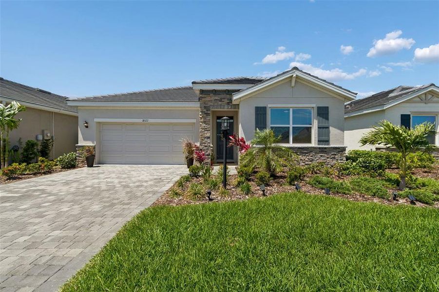 Front exterior of a new home in Star Farms at Lakewood Ranch, Bradenton, FL, highlighting curb appeal (Image 30).
