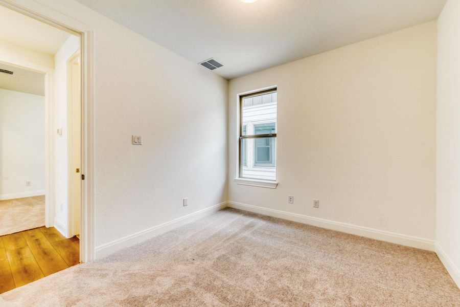 Unfurnished room with light carpet and baseboards