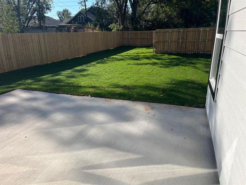 Fenced backyard with a patio area