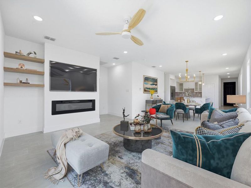 Living area featuring a ceiling fan, recessed lighting, a glass covered fireplace, light tile patterned floors, and a chandelier Virtually Staged