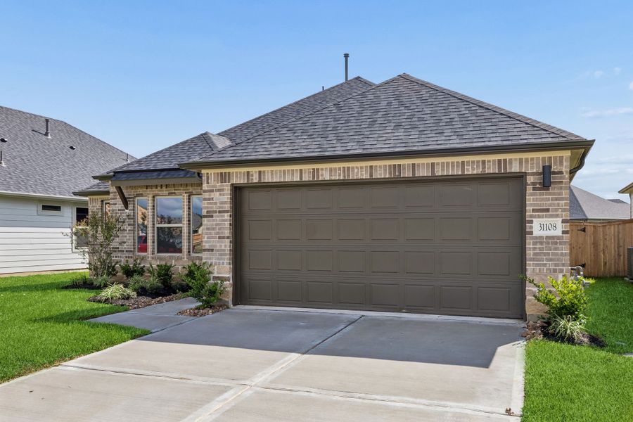 Front exterior of a new home in Riviera Pines, Huffman, TX, highlighting curb appeal (Image 19). Front exterior of a new home in Riviera Pines, Huffman, TX, highlighting curb appeal (Image 19).