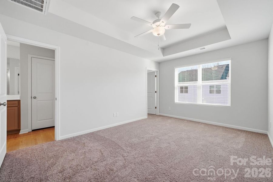 Primary Bedroom with 9' Tray Ceiling Primary Bedroom with 9' Tray Ceiling