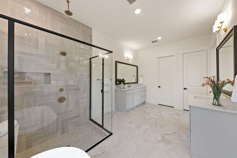 With a wonderful soaking tub and over the top walk in shower, this owner's bath is one for the ages!