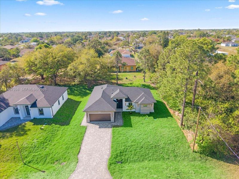 Front exterior of a new home in , Lehigh Acres, FL, highlighting curb appeal (Image 22).