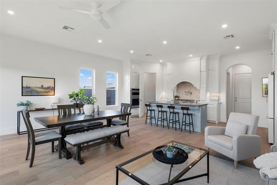 Dining space with recessed lighting, light wood-style floors, arched walkways, and ceiling fan Dining space with recessed lighting, light wood-style floors, arched walkways, and ceiling fan
