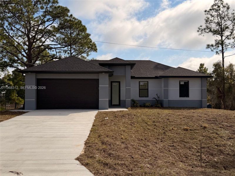 Front exterior of a new home in , Lehigh Acres, FL, highlighting curb appeal (Image 4).