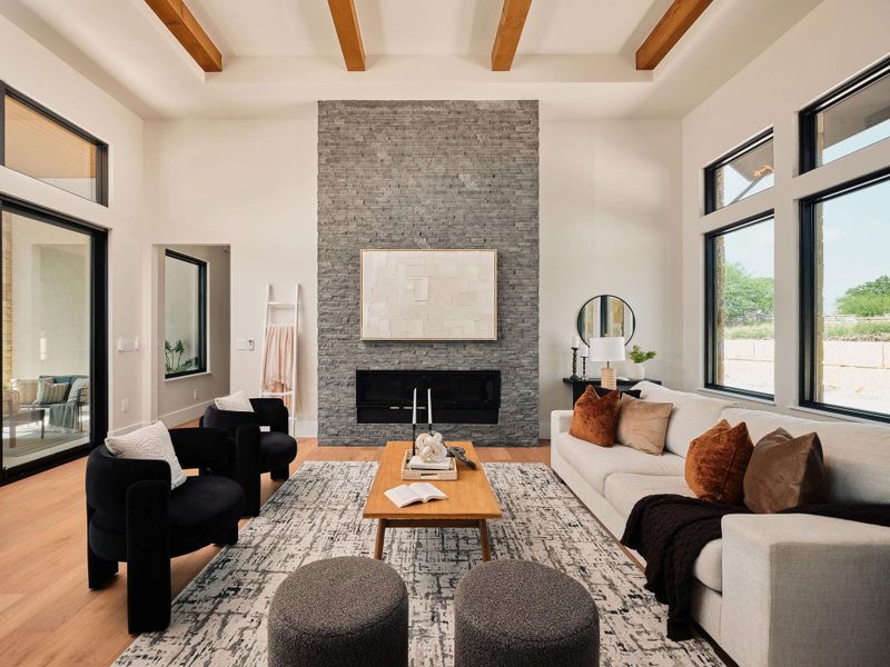 Exposed wood beams complement a soaring stone fireplace in this elegant living room. Exposed wood beams complement a soaring stone fireplace in this elegant living room.