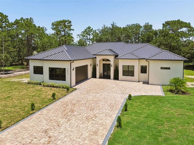 Front exterior of a new home in , Orlando, FL, highlighting curb appeal (Image 26). Front exterior of a new home in , Orlando, FL, highlighting curb appeal (Image 26).