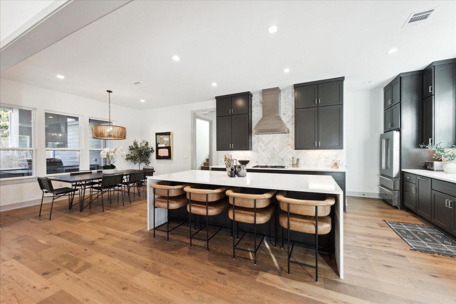 :are island with seating next to the dining area