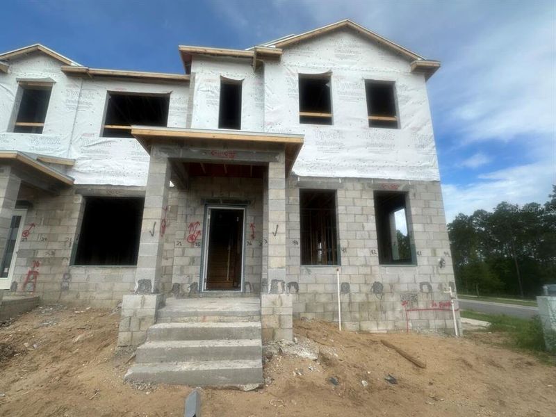 Front exterior of a new home in Tribute at Ovation, Winter Garden, FL, highlighting curb appeal (Image 1).