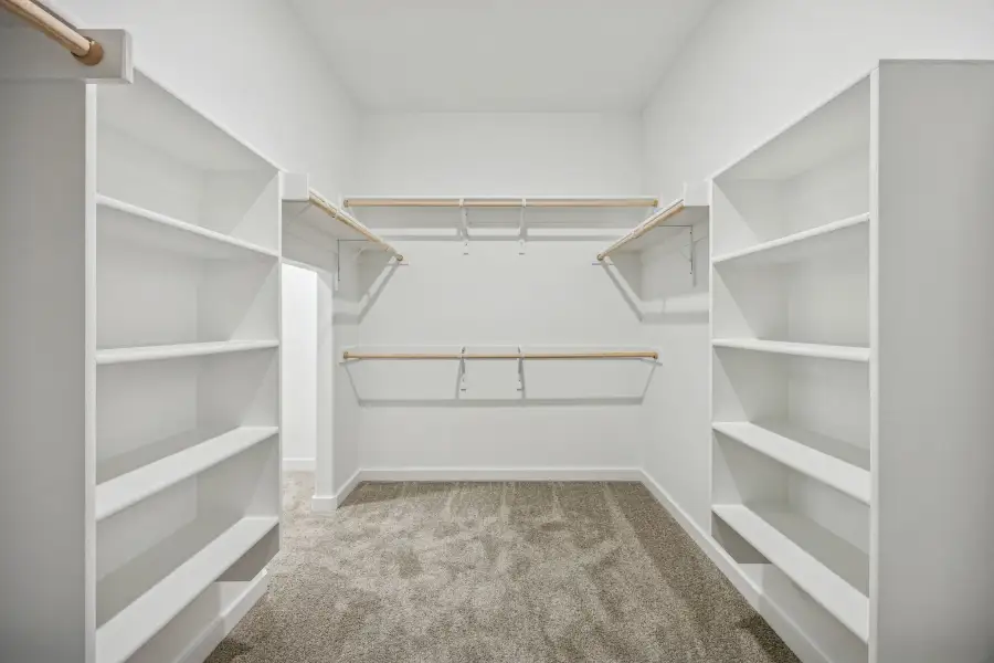 Primary Closet in the Wimbledon home plan by Trophy Signature Homes – REPRESENTATIVE PHOTO Primary Closet in the Wimbledon home plan by Trophy Signature Homes – REPRESENTATIVE PHOTO